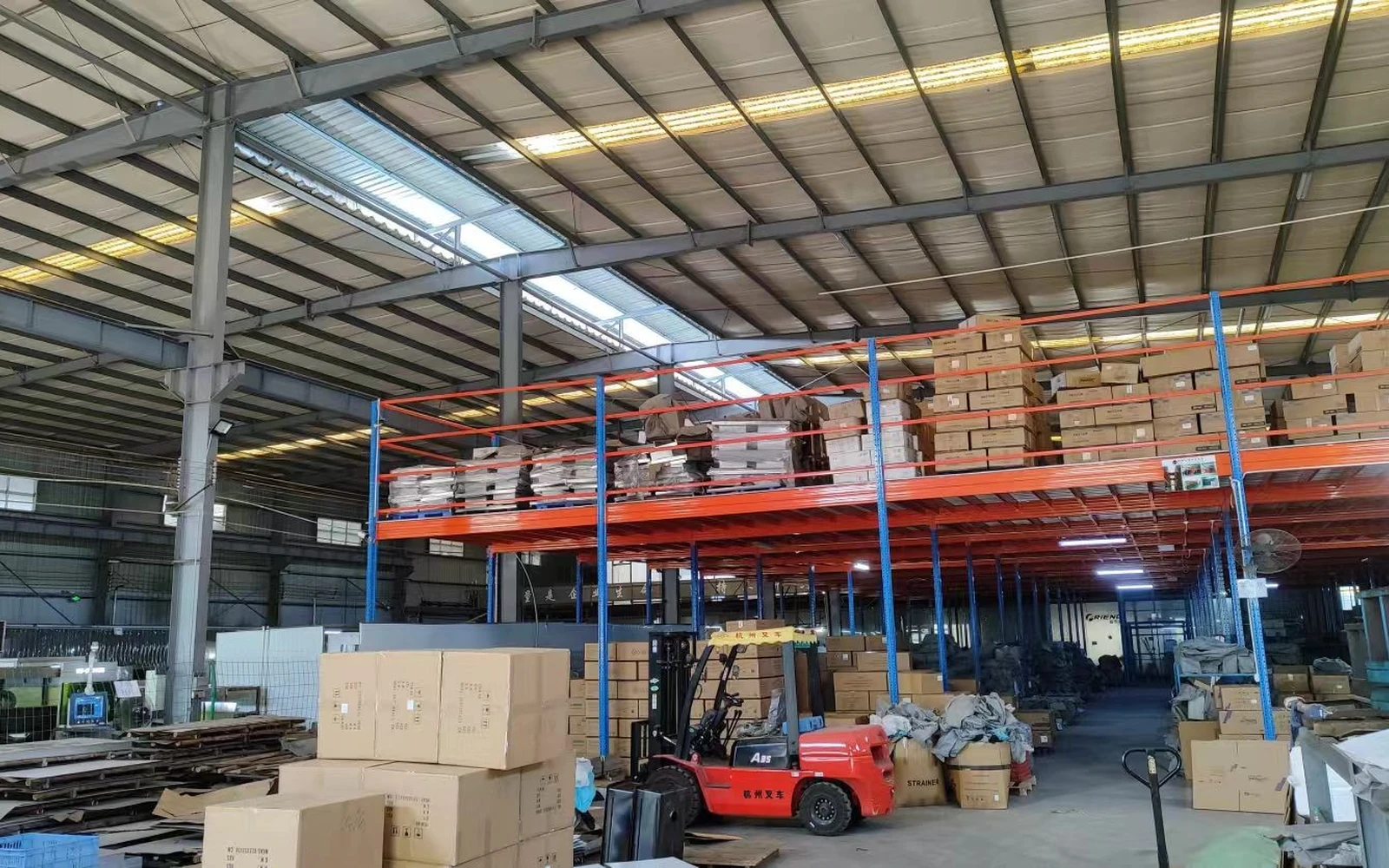 Finished-goods warehouse with shelving and a forklift